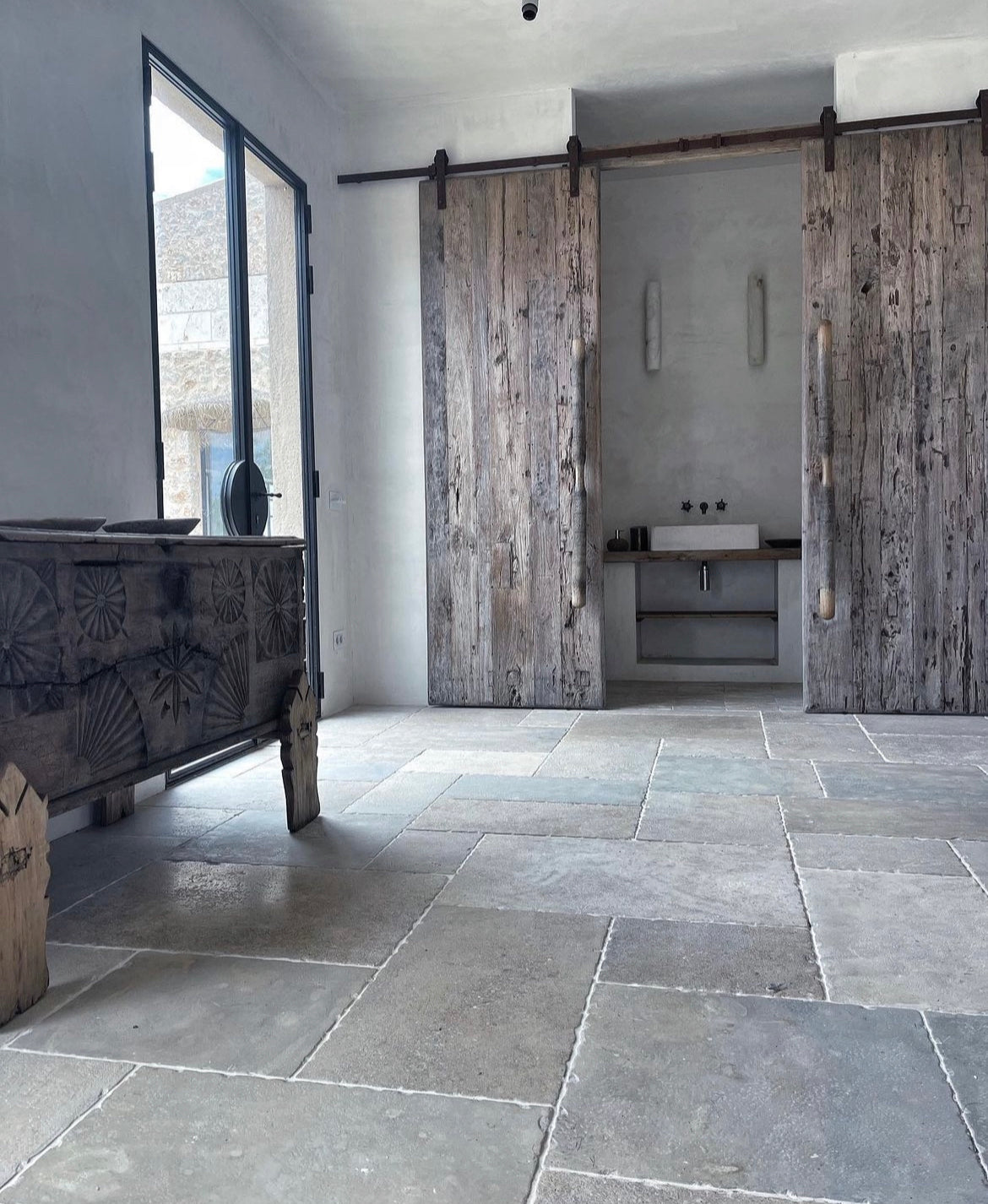 Bathroom with wooden sliding doors and stone flooring